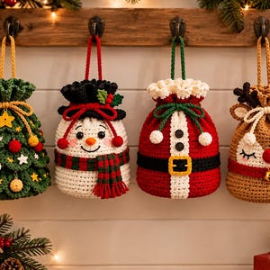 May include: Four crocheted drawstring bags hanging on hooks. The first is a green Christmas tree with ornaments, the second a white snowman with a plaid scarf, the third a red Santa suit with a belt, and the fourth a brown reindeer with a red nose.