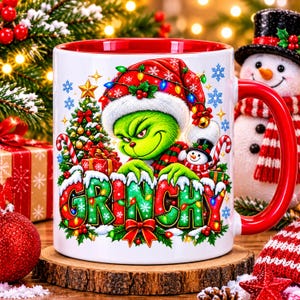 May include: A white ceramic mug with a red interior and handle, featuring a colorful graphic of a green character wearing a Santa hat, a decorated Christmas tree, gifts, and a small snowman, with the word GRINCHY in large, festive lettering.