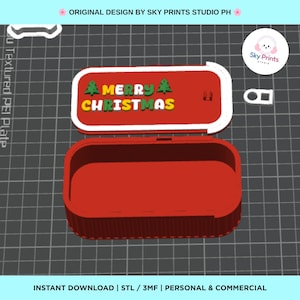 May include: A red rectangular 3D printed container with a sliding lid. The lid features the text MERRY CHRISTMAS in yellow and white letters, flanked by two green pine tree icons. The container has a hollow interior and a white sliding mechanism.