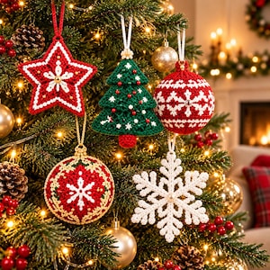 May include: Five crocheted Christmas ornaments hanging on a tree: a red star with white trim, a green tree with red and white accents, a red ball with white patterns, a red ball with gold and white details, and a white snowflake ornament.