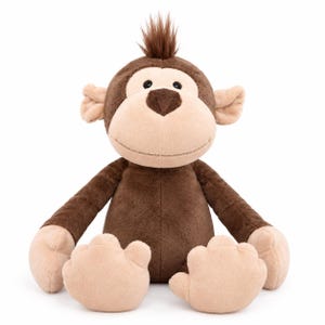 May include: A plush monkey toy featuring dark brown fur on the body and head, with light beige fur on the face, ears, hands, and feet. The monkey has a small tuft of brown hair on top of its head, black button eyes, and a stitched nose.