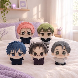 May include: Five plush dolls featuring stylised anime-inspired characters with distinct hair colours including pink, green, blue, dark brown, and grey. Each doll has large embroidered eyes, a small mouth, and wears a unique outfit in dark tones.