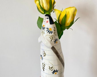 Lady vase with bunch of flowers