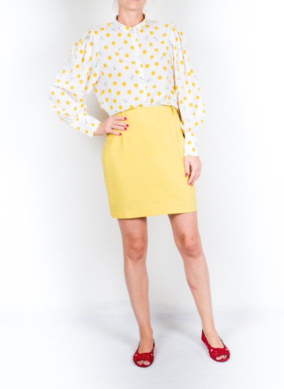 yellow and white polka dot blouse
