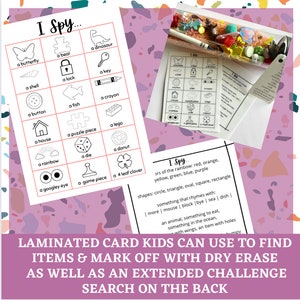 May include: A laminated card game with a grid of images and the text "I Spy..." at the top. The images include a butterfly, a bear, a dinosaur, a shell, a lock, a key, a button, a fish, a crayon, a house, a puzzle piece, a lego, a rainbow, a die, a donut, a googley eye, a game piece, and a four-leaf clover. The card is designed for kids to find the items and mark them off with a dry erase marker. The back of the card has an extended challenge.