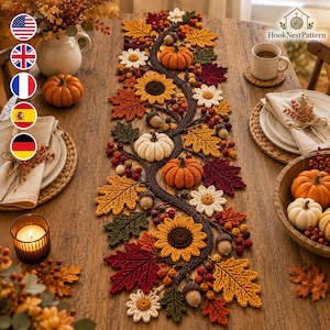 Peut inclure: Un chemin de table en crochet composé d'une vigne brun foncé sinueuse ornée de citrouilles orange et blanches, de tournesols jaunes, de marguerites blanches et de feuilles aux couleurs automnales rouges, orange et vertes, avec des glands.