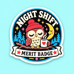 May include: A circular embroidered patch featuring a brown owl wearing a red beanie, perched on a branch, holding a white mug with a red heart. The text reads NIGHT SHIFT and MERIT BADGE, surrounded by a yellow crescent moon, blue trees, and stars.