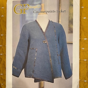 May include: A sewing pattern for a Counterpoints Jacket by gailpatricedesign. The jacket is blue with brown trim and a unique asymmetrical design. The pattern is on a white background.