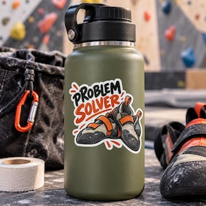 May include: An olive green insulated water bottle with a black screw-top lid. A sticker on the front features an illustration of two climbing shoes and the text "PROBLEM SOLVER" in black and orange lettering against a white background.