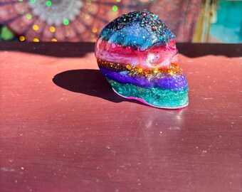 Multi-colored skull paperweight.