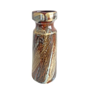 May include: A brown and white ceramic vase with a textured, abstract design. The vase has a wide mouth and a narrow base.