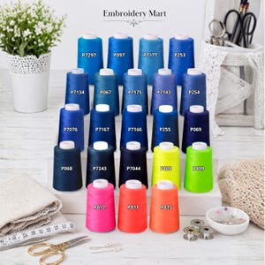 May include: A collection of twenty embroidery thread spools arranged in rows, featuring various shades of blue, neon yellow, neon pink, and neon orange. Each spool is labeled with a specific product code, such as P7297, P097, P7177, P253, P7134, P067, P7175, P7143, P254, P7076, P7167, P7166, P255, P069, P068, P7243, P7044, P808, P809, P812, P811, and P815. The text Embroidery Mart is visible at the top.