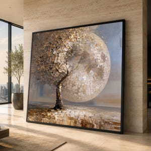 May include: A large square wall art piece in a black frame featuring an abstract painting of a tree with a textured, metallic gold and silver spherical canopy. The ground is depicted with scattered, reflective square brushstrokes in brown and gold.