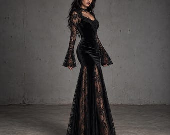 May include: A floor-length black velvet dress featuring long, flared lace sleeves and a matching lace bodice overlay. The garment includes a fitted waist, a sweetheart neckline, and a skirt with vertical lace panels that extend to the hemline.