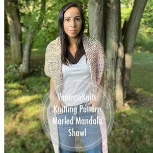 May include: A woman wearing a knitted shawl with a marled mandala pattern. The shawl transitions from beige to pink. The text "VanessaKnits Knitting Pattern Marled Mandala Shawl" is visible.