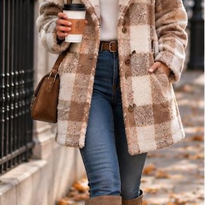 May include: A beige and white plaid textured coat with a notched collar and buttons, worn over a white ribbed turtleneck sweater, blue denim jeans, and brown knee-high boots, accompanied by a brown leather shoulder bag and dark sunglasses.