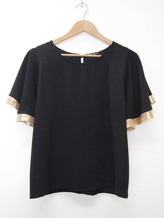black top with sequin sleeves