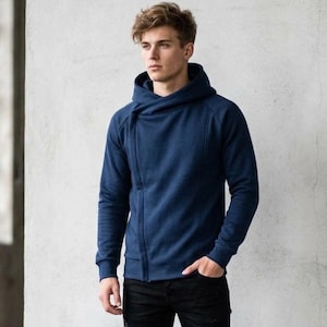 May include: A navy blue pullover hoodie featuring a unique asymmetrical crossover neckline, long sleeves with ribbed cuffs, and a structured hood. The garment is constructed with visible vertical seam detailing along the front torso.