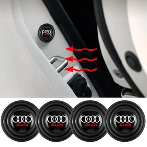 May include: Four circular black rubber shock-absorbing pads featuring the white Audi logo and red text. The pads are designed to be applied to a car door frame near the metal door latch, as shown in the demonstration image with red arrows.