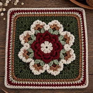 May include: A square crochet motif featuring a central dark red flower with cream petals, surrounded by sage green and brown accents on a dark green background. The border consists of alternating rows of cream, brown, and dark red yarn stitches.