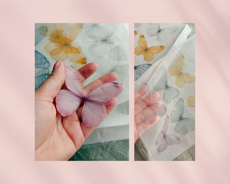 May include: A delicate, translucent, pink butterfly is held in a hand, with a sheet of paper featuring various butterfly designs in the background. The butterflies on the paper are in shades of yellow, blue, and white.