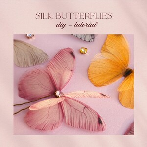May include: Silk butterflies in shades of pink and orange are arranged on a pink surface, with a few sparkling embellishments. The text "SILK BUTTERFLIES diy - tutorial" is at the top of the image.