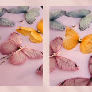May include: A collection of delicate butterfly hair pins in shades of pink, yellow, and blue. Each butterfly has intricate wing details and a sparkling gem center. The pins are arranged on a soft pink surface, creating a whimsical and elegant aesthetic.