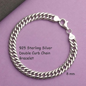 May include: A 925 sterling silver double curb chain bracelet with a lobster claw clasp. The metal links are polished and reflective. The text 925 Sterling Silver Double Curb Chain Bracelet and 8 mm is printed clearly on the image surface.