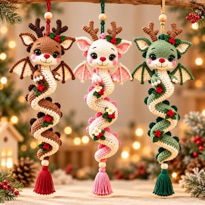 May include: Three crocheted dragon ornaments with deer antlers, each featuring a long coiled body, small wings, and festive holly berry accents. The dragons are brown, white, and green, finished with wooden beads and matching yarn tassels.