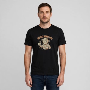 Okayest Mummy Ever funny Halloween dad pun t-shirt on male model, black Gildan 5000 tee with mummy graphic — spooky season gift.