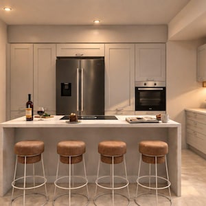May include: A kitchen interior featuring light grey cabinetry, a central island with a white countertop, and four brown upholstered bar stools with white metal legs. A stainless steel refrigerator, built-in oven, and sink are visible.