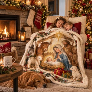 May include: A plush throw blanket featuring a detailed nativity scene with Mary, Joseph, and the infant Jesus in a manger, surrounded by a cow, donkey, and lambs. The blanket has a cream-colored sherpa fleece backing and a festive holiday border.