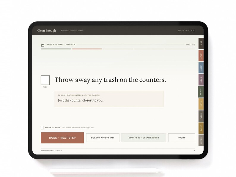 May include: A digital tablet displaying a Clean Enough cleaning planner interface. The screen shows the text, Throw away any trash on the counters, with a sub-instruction, Just the counter closest to you, and navigation buttons labeled Done, Next Step, Skip, and Rooms.