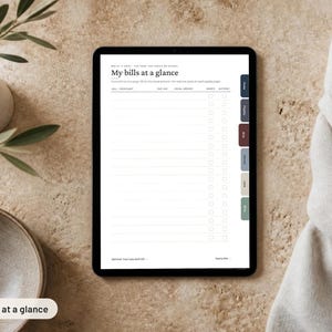 May include: A digital tablet displaying a financial tracking template titled My bills at a glance. The screen features columns for bill or merchant, due date, total amount, and checkboxes, with a vertical tab menu on the right side of the screen.