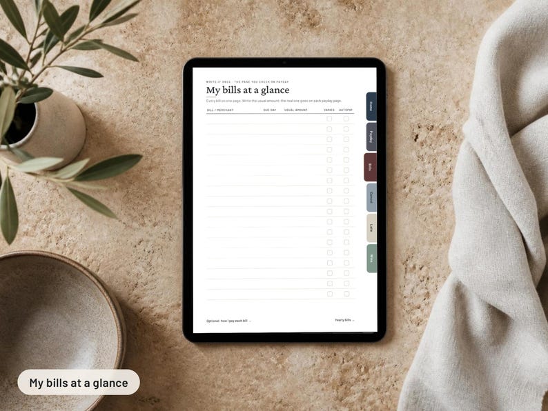 May include: A digital tablet displaying a financial tracking template titled My bills at a glance. The screen features columns for bill or merchant, due date, total amount, and checkboxes, with a vertical tab menu on the right side of the screen.
