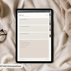 May include: A digital tablet displaying a 2027 planner page with the text Hello, 2027. The screen features three prompt boxes and a checklist section with checkboxes. The interface includes a dark gray header and a side navigation bar with tabs.