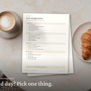 May include: A printed checklist titled Low-energy menu with categories for 2 minutes, 5 minutes, 10 minutes, and sitting down tasks. The document features checkboxes and text lines for organizing daily chores, presented on a light background.