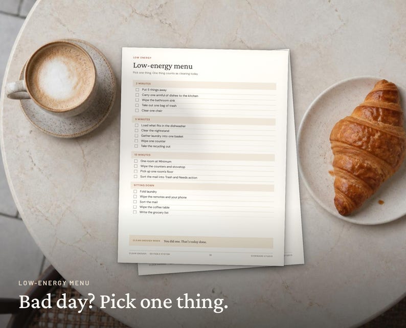 May include: A printed checklist titled Low-energy menu with categories for 2 minutes, 5 minutes, 10 minutes, and sitting down tasks. The document features checkboxes and text lines for organizing daily chores, presented on a light background.