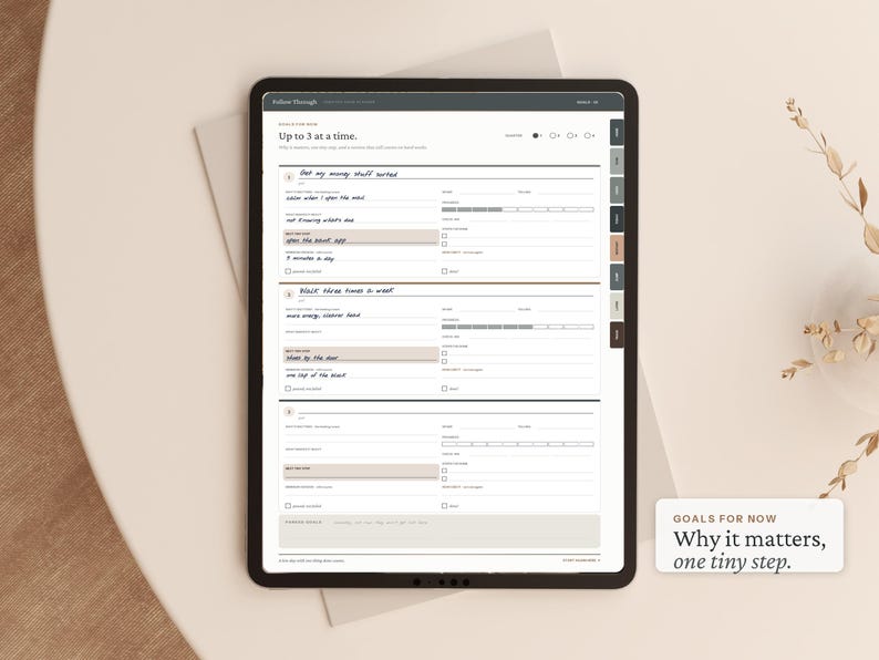 May include: A digital tablet displaying a goal-tracking planner interface with the text 'Up to 3 at a time' and 'GOALS FOR NOW Why it matters, one tiny step.' The screen features structured sections for daily habits, progress bars, and checkboxes.