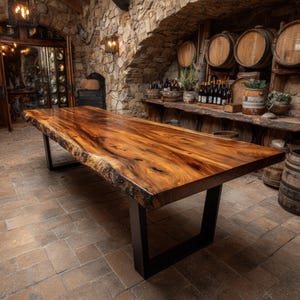 May include: A large rectangular dining table featuring a polished live edge wood slab top with prominent natural grain patterns and dark knots, supported by two sturdy black metal U-shaped legs resting on a stone floor.