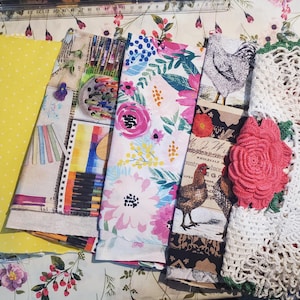 May include: A collection of fabric swatches including a yellow polka dot print, a bee and hive print with text reading HONEY BEE FARM, a floral pattern, a chicken and rooster print, and a white crocheted doily with a pink flower applique.