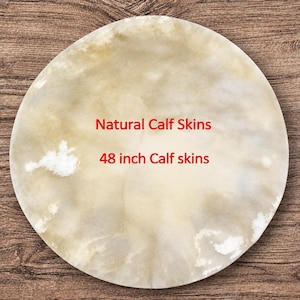 May include: A circular piece of natural calf skin with a mottled beige and white surface. The text Natural Calf Skins and 48 inch Calf skins is printed in red across the centre of the hide, which measures 121.92 cm in diameter.