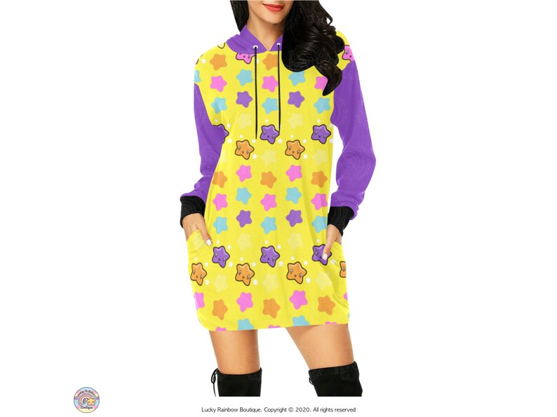 May include: A yellow hooded dress with a purple trim and a pattern of colourful stars with smiling faces.