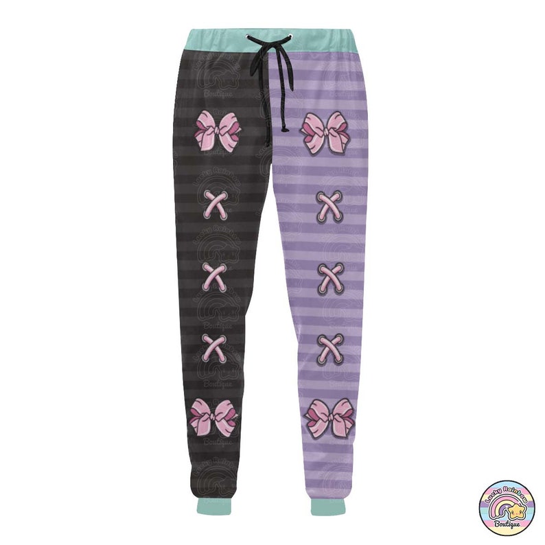 Op de afbeelding: Zwart en paars gestreepte sweatpants met roze strikken en een X-patroon op de benen.