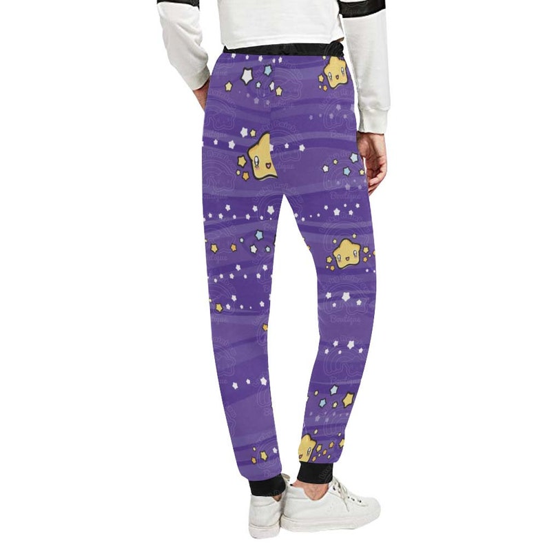 May include: Purple sweatpants with a whimsical pattern of yellow stars with faces and blue and white stars on a purple background.