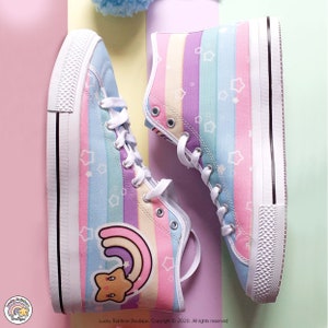 Kawaii High Top Sneakers with a Pastel Rainbow and Stars Stripe background. Features a Large Rainbow Star Graphic on the outer side. Rubber Soles. Lace Up. Vegan friendly.