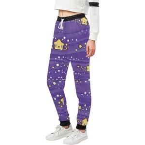 May include: Purple sweatpants with a pattern of yellow stars with faces and white outlines. The stars are scattered on a purple background with white stripes.