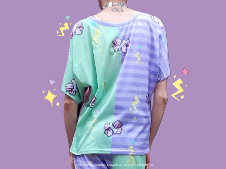 May include: A green and purple t-shirt with a split design. The left side is green with a light blue and pink candy cane pattern and the right side is purple with a light blue stripe pattern. Both sides have a white lightning bolt and heart pattern.