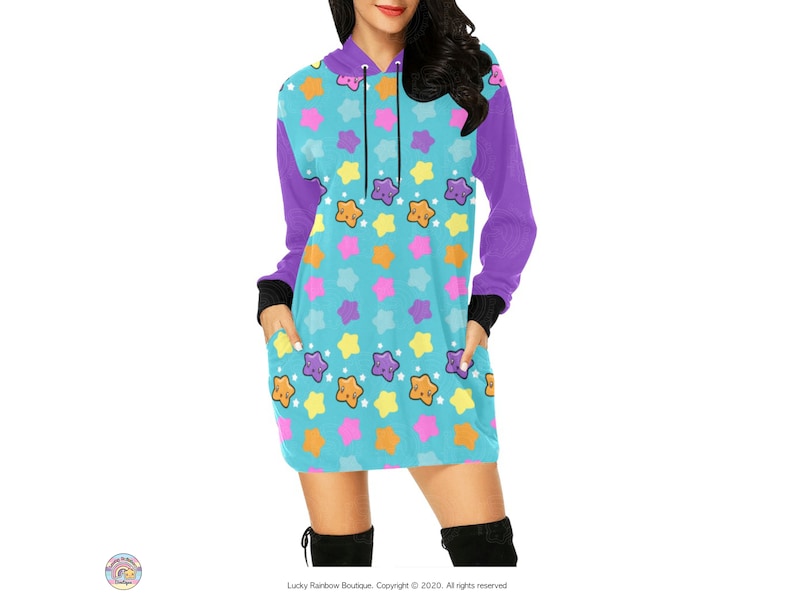 May include: A turquoise blue hooded dress with a purple sleeve and a pattern of colourful stars with smiling faces.