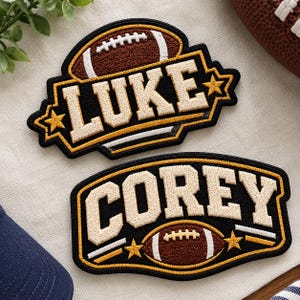 May include: Two embroidered patches featuring football themes. One patch displays the name LUKE in cream letters on a black background with a football icon and gold stars. The second patch shows the name COREY with a football and stars.